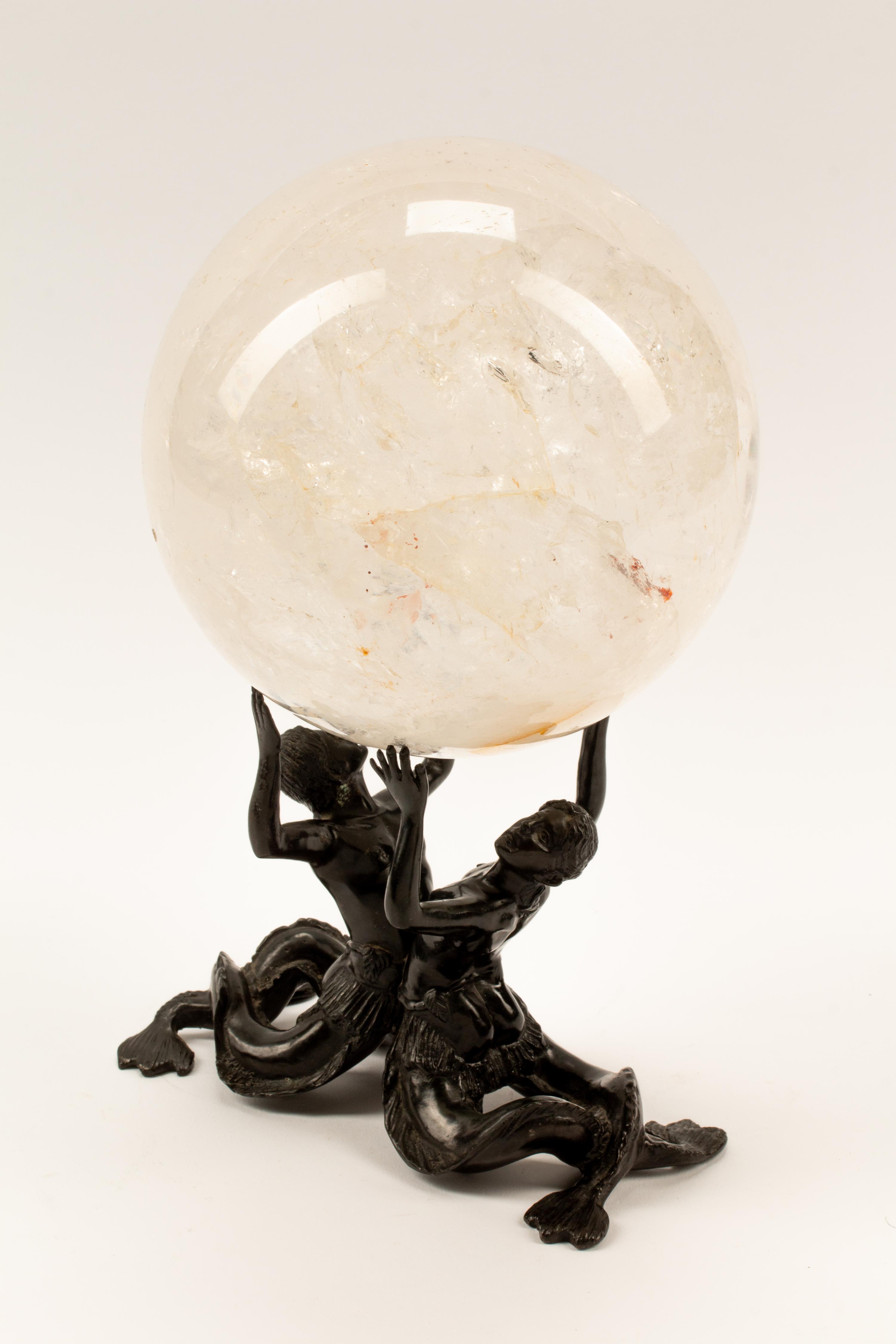 A Rock Crystal Spherical Ornament on a Patinated Bronze Figural Base
