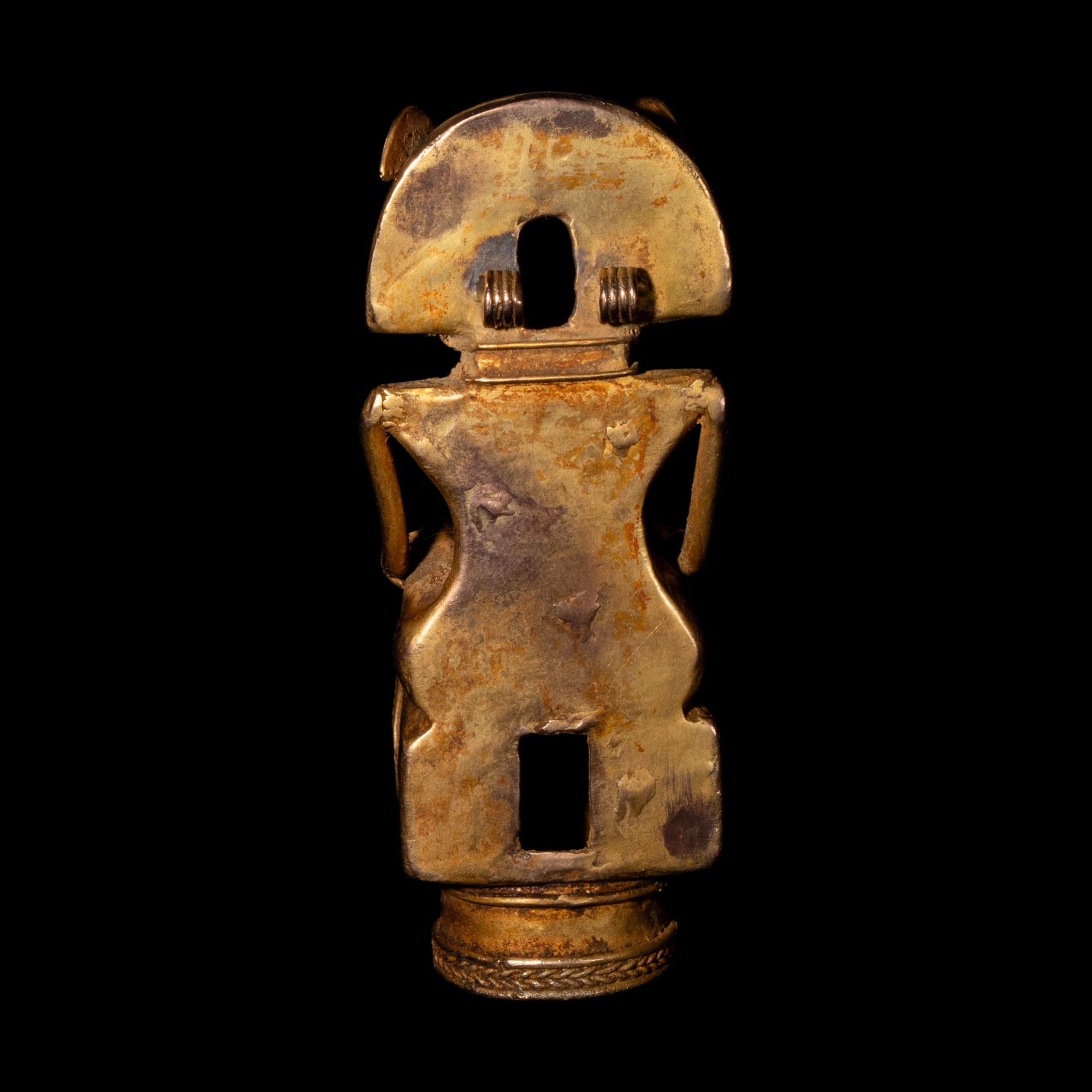 A Tairona Tumbaga Finial with a Shaman atop a Bird