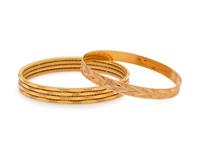 COLLECTION OF YELLOW GOLD BANGLE BRACELETS