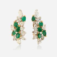 A pair of diamond, emerald, gold, and platinum ear clips