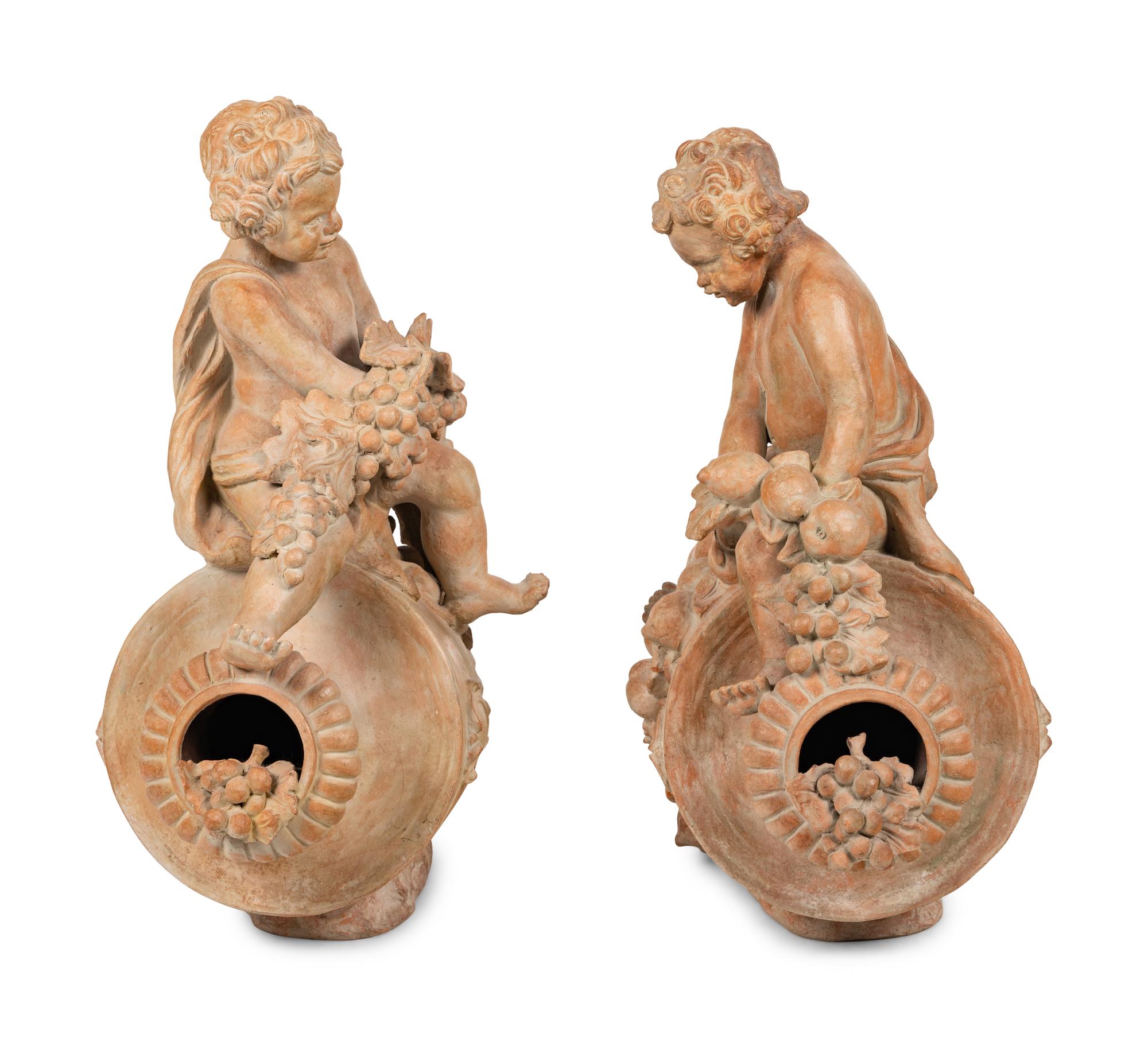 A Pair of Terra Cotta Putti Ornaments