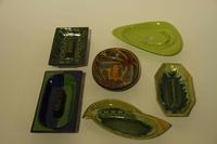 A Collection of Thirteen Haeger Pottery Ash Receivers Width of widest 18 1/2 inches.