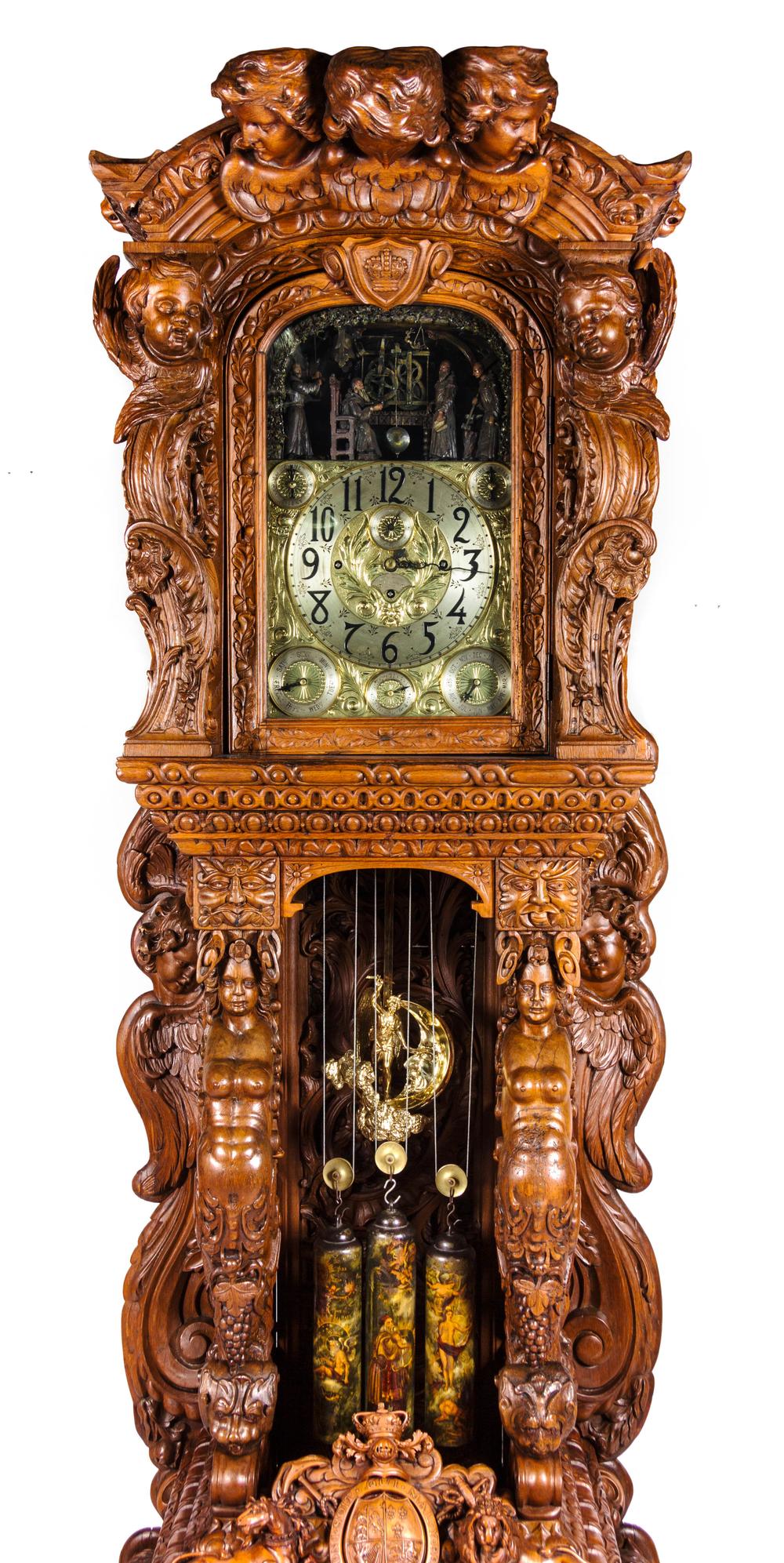 A Monumental English Carved Oak Tall Case Clock, LAST QUARTER 19TH CENTURY, Height 130 1/2 x width 48 x depth 33 inches.