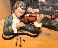 A Lladro Violinist with Violin and Bow. Height 13 1/4 inches.