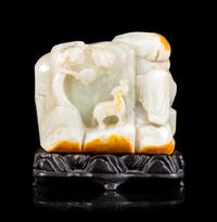 A Chinese Celadon and Russet Jade Boulder