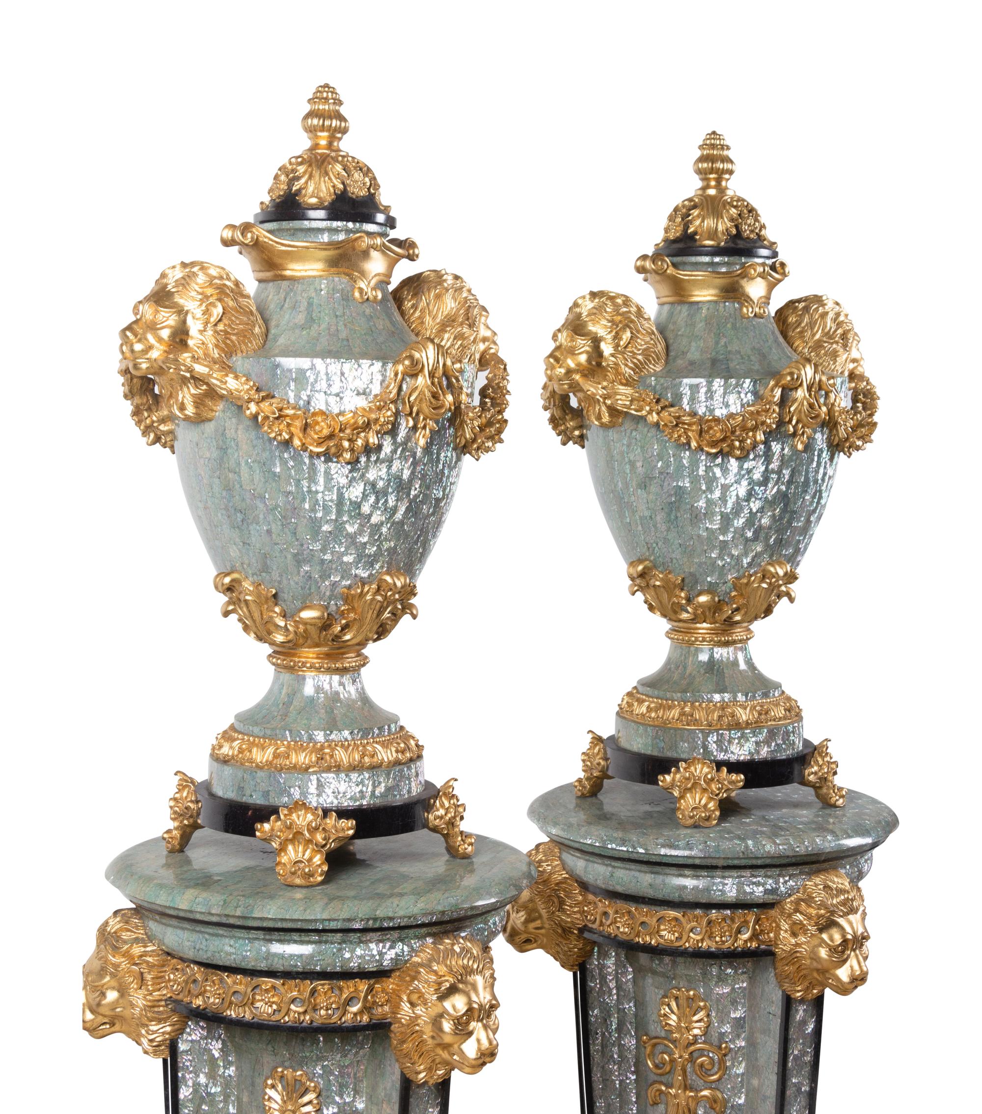 A Pair of Neoclassical Style Gilt Composite and Abalone Veneered Urns and Pedestals