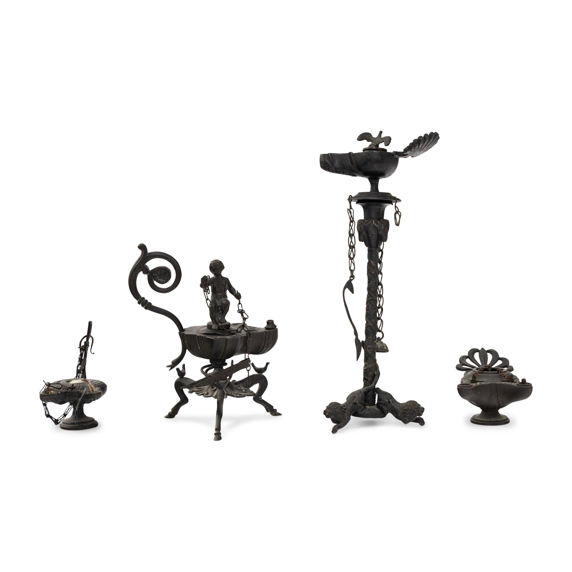 A Collection of Four Patinated Bronze Oil Lamps