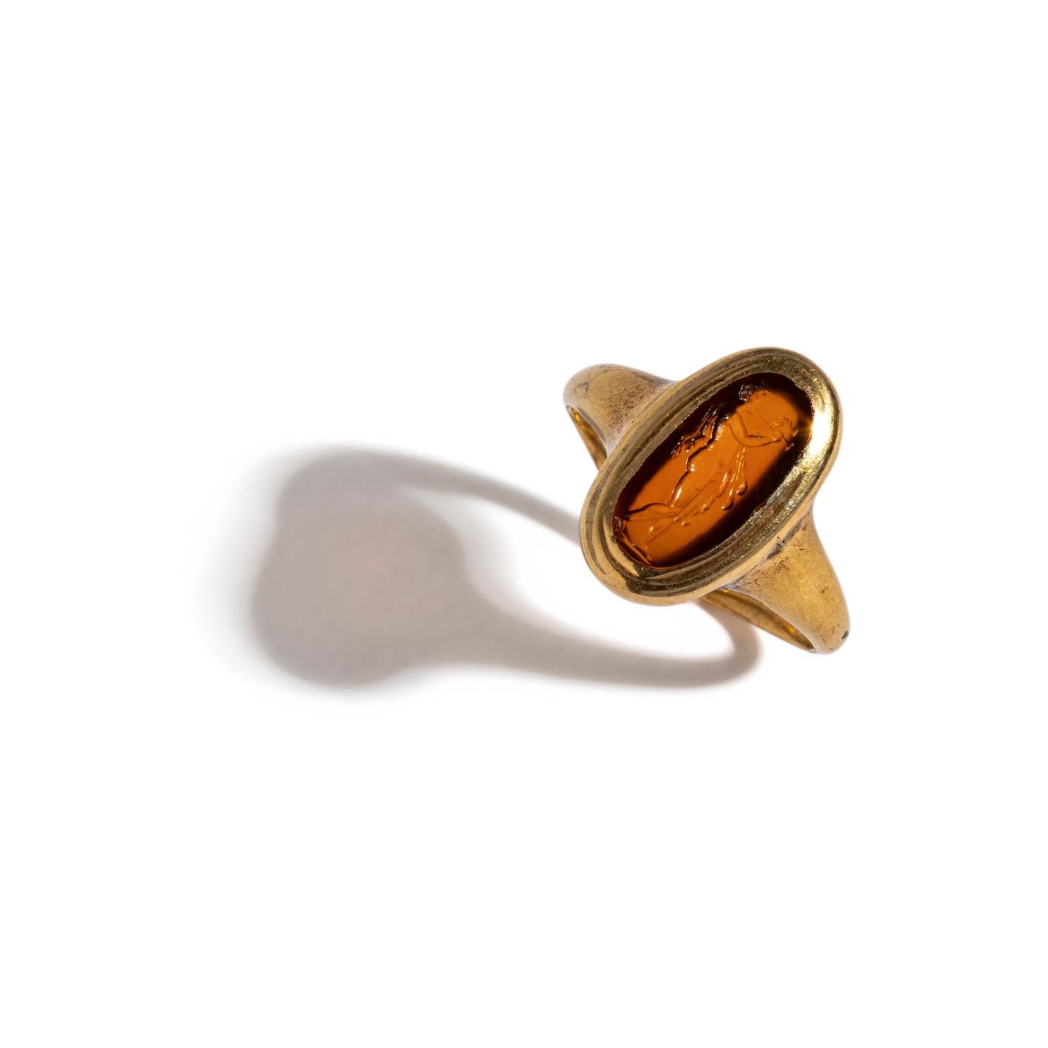 A Roman Carnelian Ring Stone with the God Silenus Playing an Aulos — Set in a gold ring