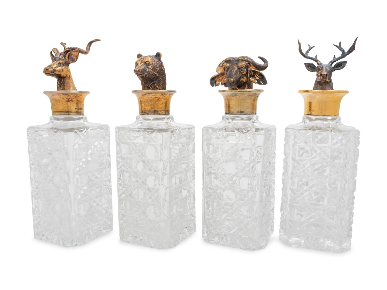 A Set of Four English Silver Mounted Cut-Glass Decanters