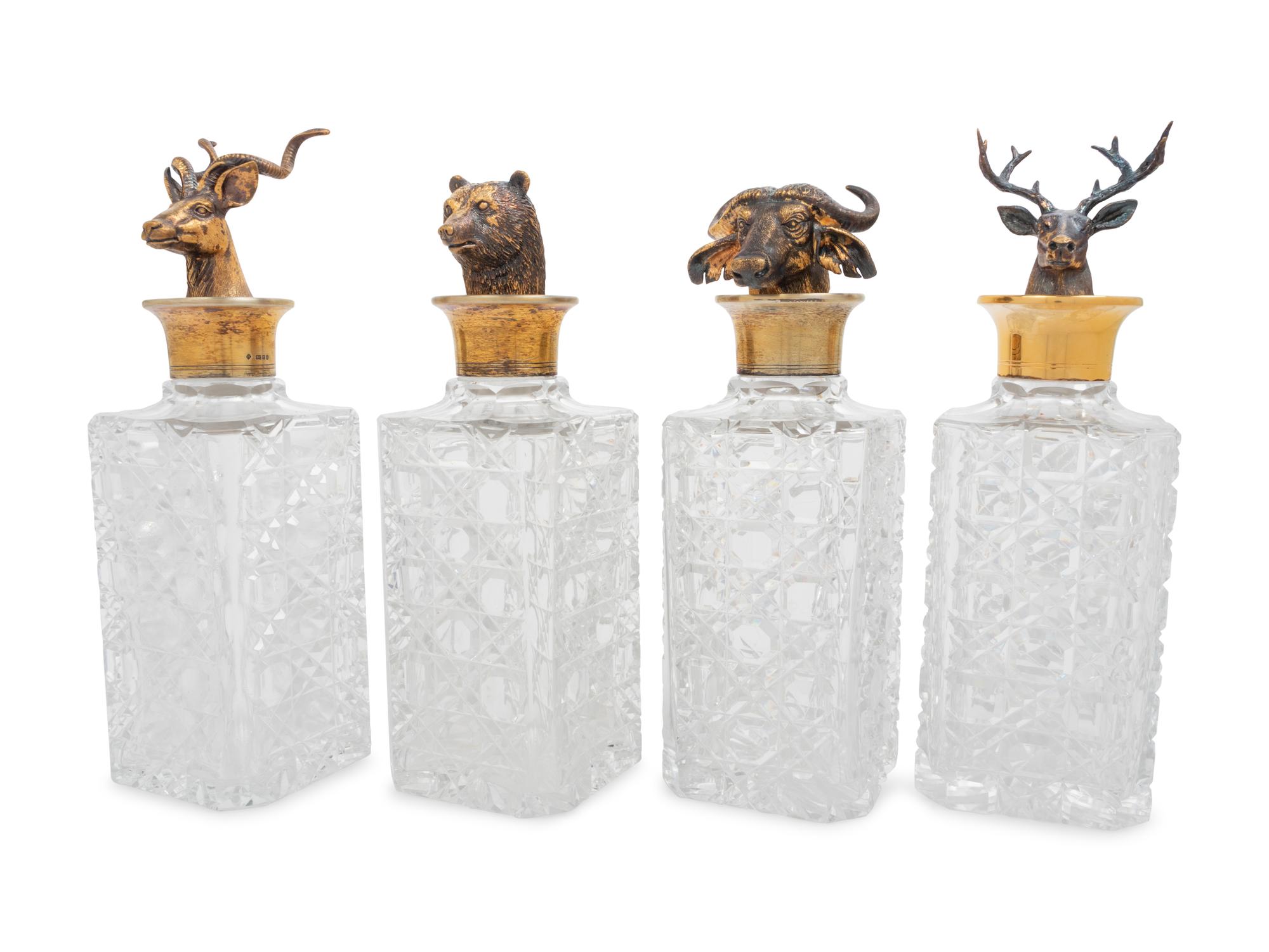 A Set of Four English Silver Mounted Cut-Glass Decanters