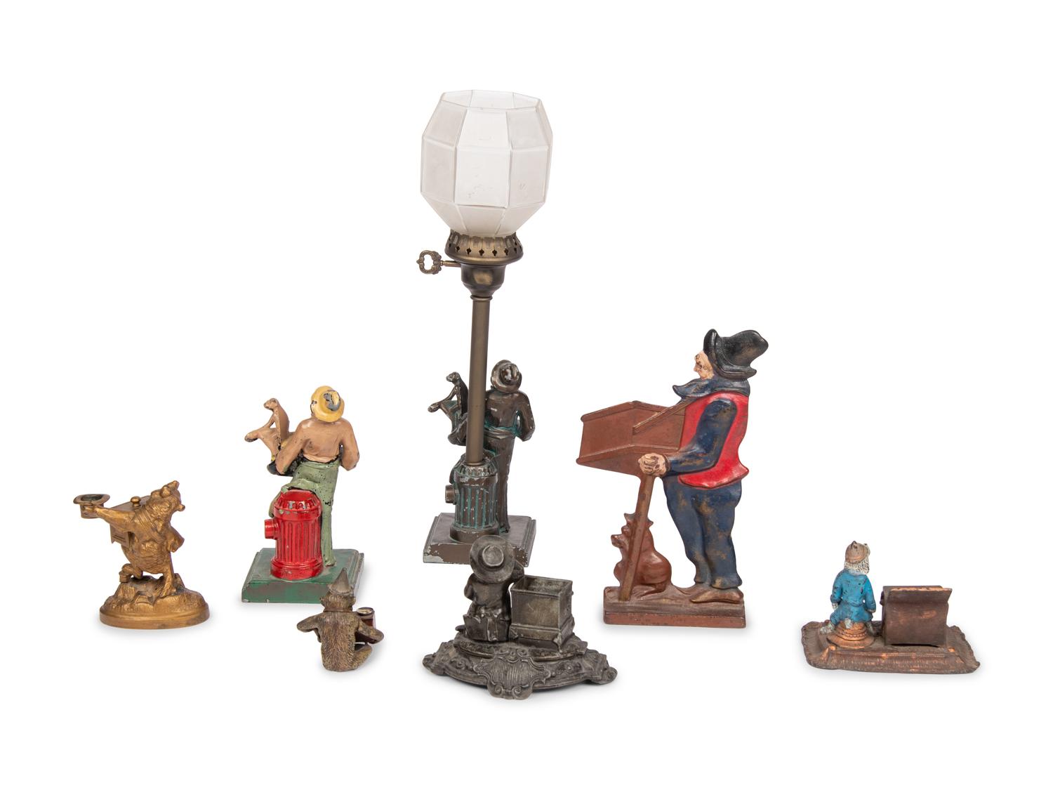 A Group of Seven Barrel Organ Themed Metal Items