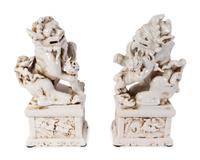 A Pair of Chinese Blanc de Chine Porcelain Fu-Lions on Pedestal Bases — 19TH/20TH CENTURY