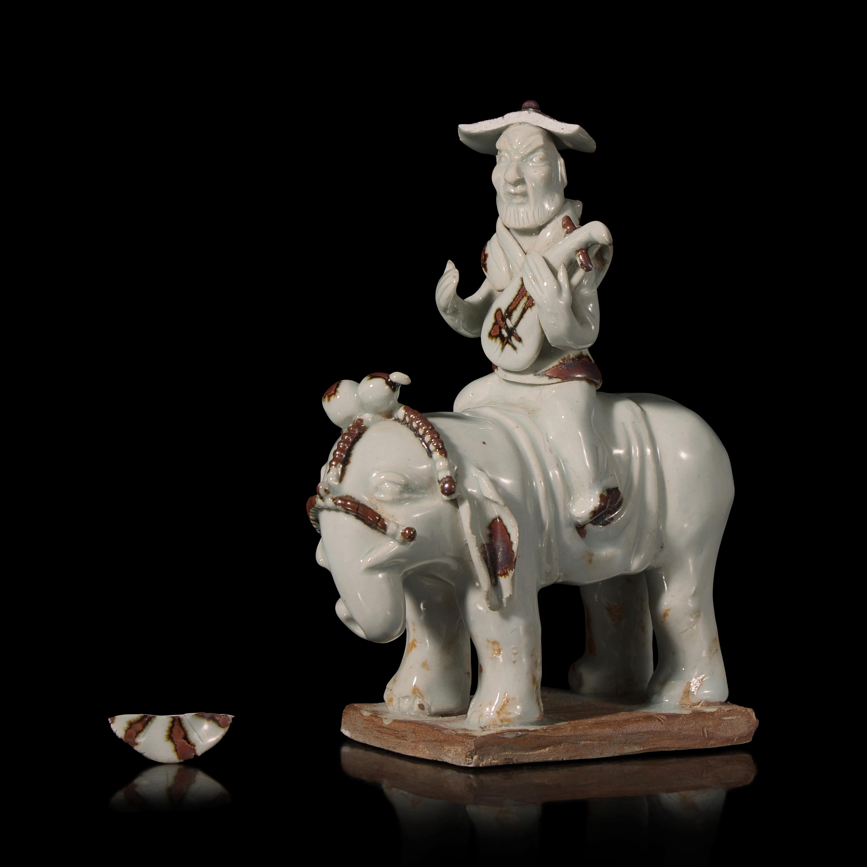 A Chinese Hutian Spotted Qingbai Glazed Porcelain Foreign Musicians Riding an Elephant — 湖田窯青白釉胡人琵琶騎象俑