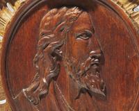 A Flemish carved oak bas relief profile portrait of Christ, 17th century