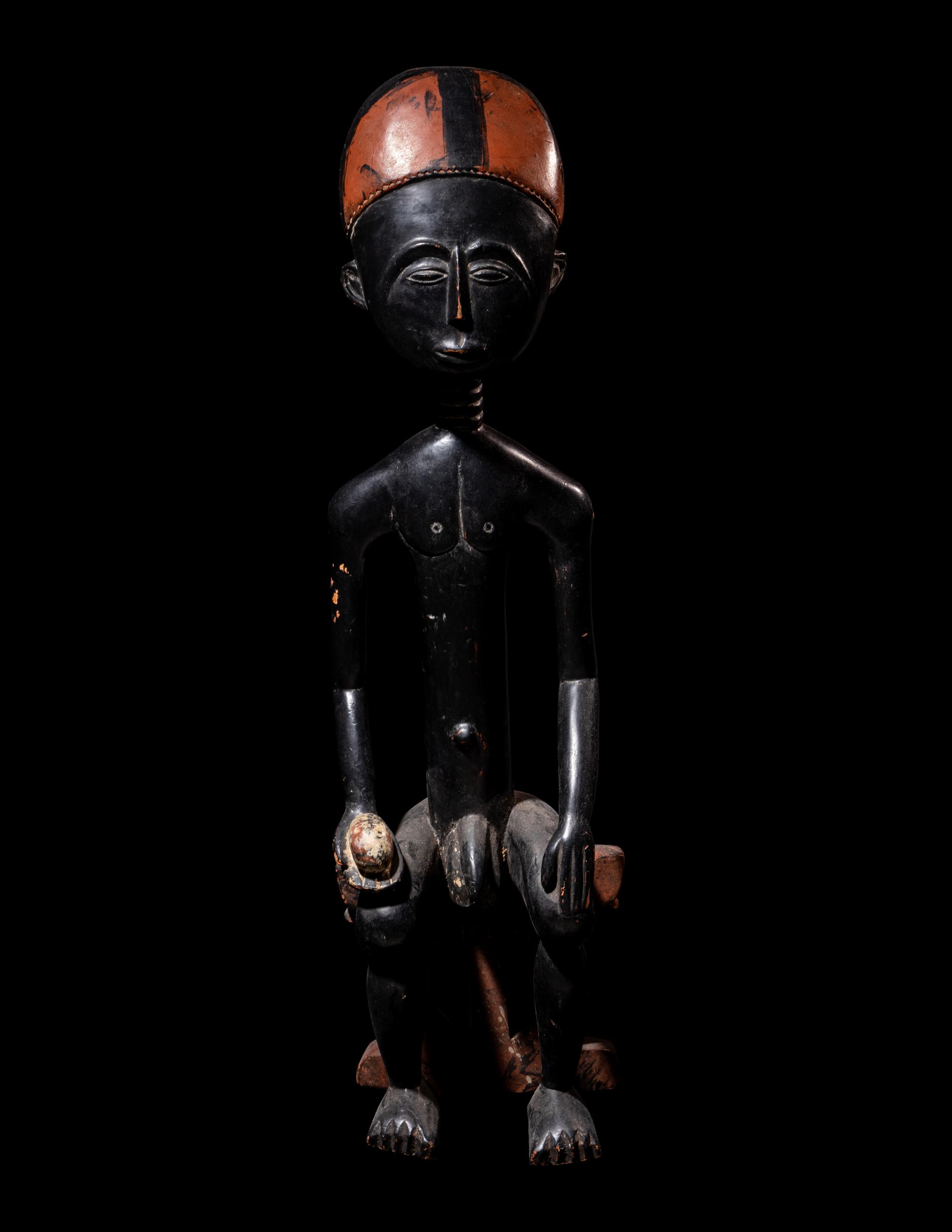 An Akan Wood Figure Seated on a Throne