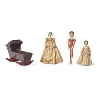 A Group of Three Peg Wooden Dolls and a Miniature Wood Cradle