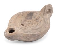 A Roman Discus Lamp Depicting Dionysos Holding a Thyrsos and a Bunch of Grapes