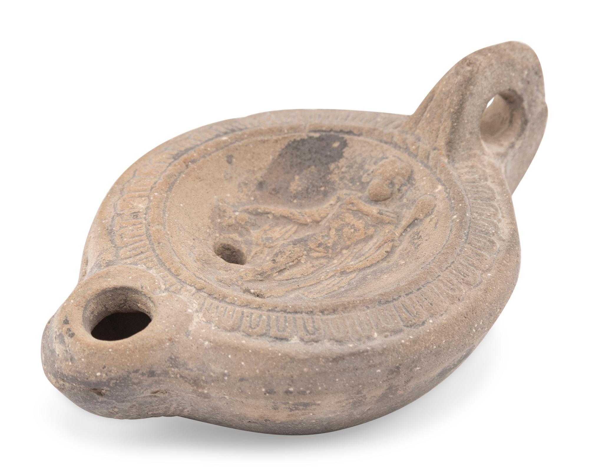A Roman Discus Lamp Depicting Dionysos Holding a Thyrsos and a Bunch of Grapes