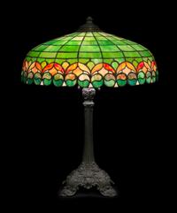 Wilkinson Co., EARLY 20TH CENTURY, a leaded glass table lamp, the domed shade with floral lower border, raised on a cast metal base