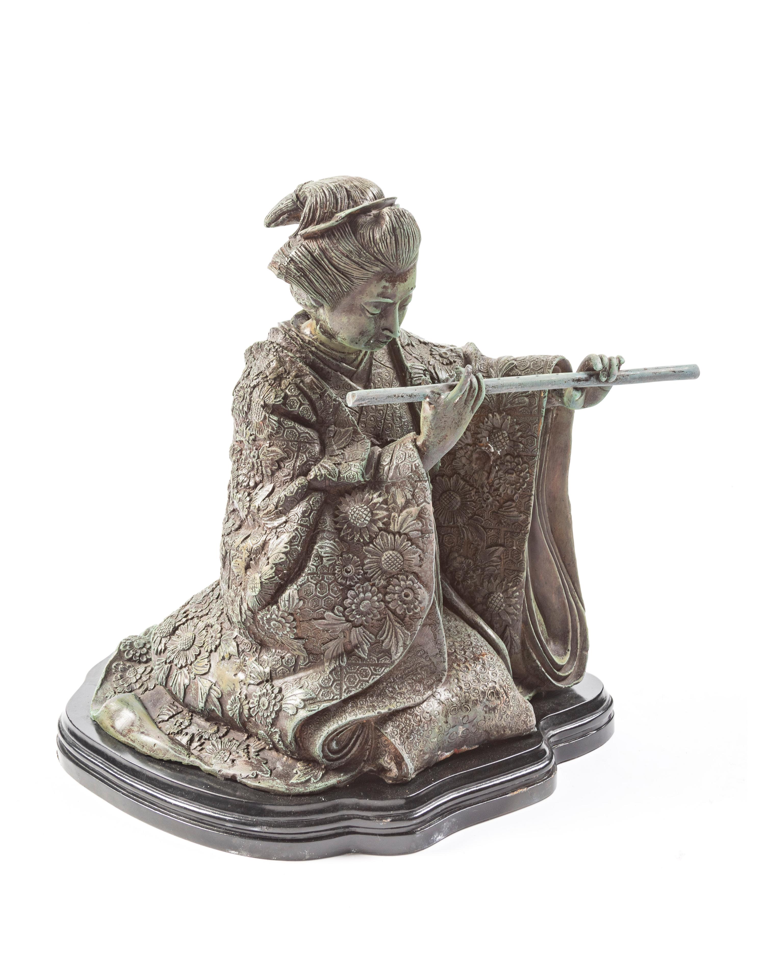 A Japanese Bronze Figure of a Woman Playing the Flute