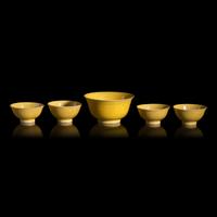 A Group of Five Chinese Incised Yellow Glazed Porcelain "Dragon" Bowls, 19th/20th Century — 清晚期 黃釉暗刻龍紋碗一組五件