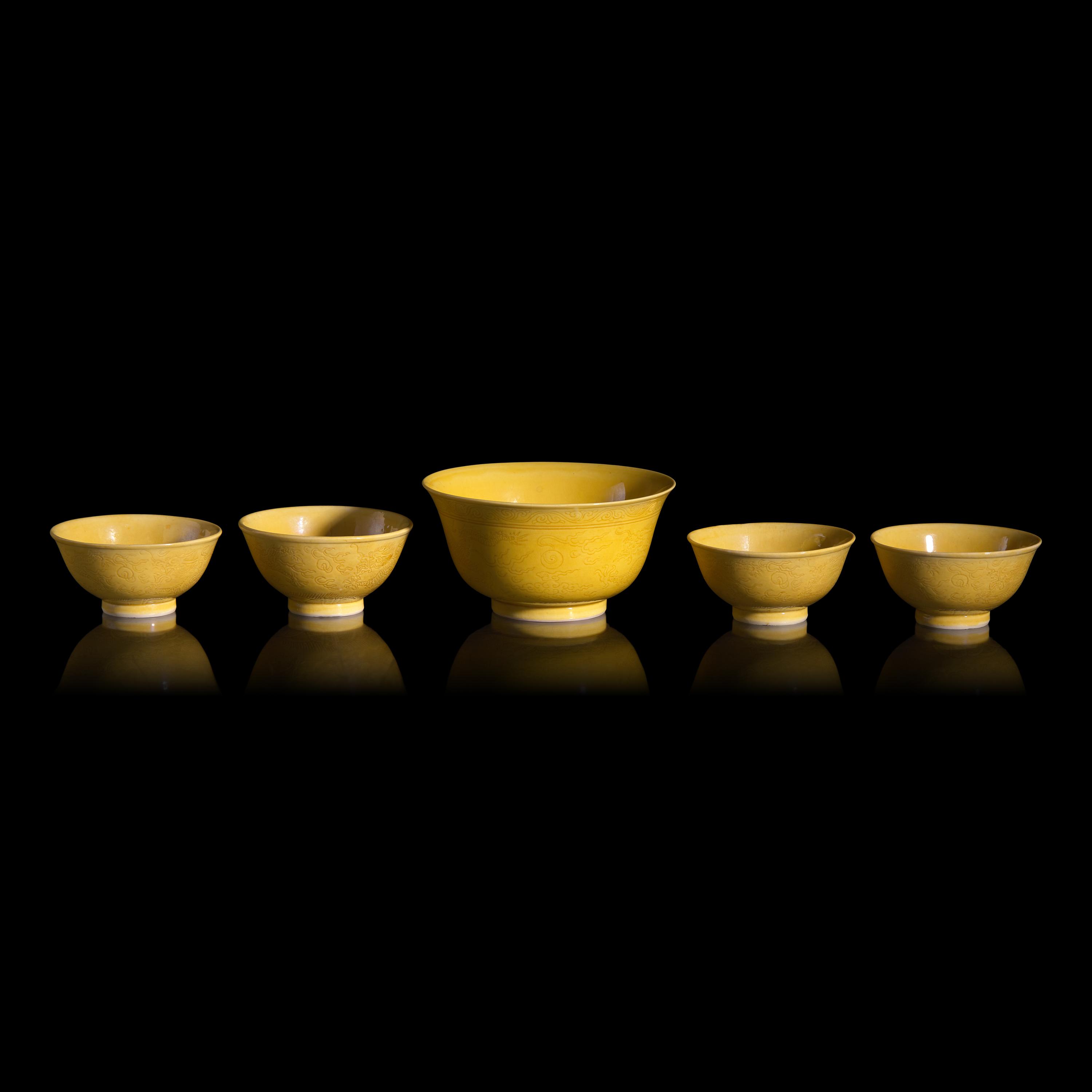 A Group of Five Chinese Incised Yellow Glazed Porcelain "Dragon" Bowls, 19th/20th Century — 清晚期 黃釉暗刻龍紋碗一組五件
