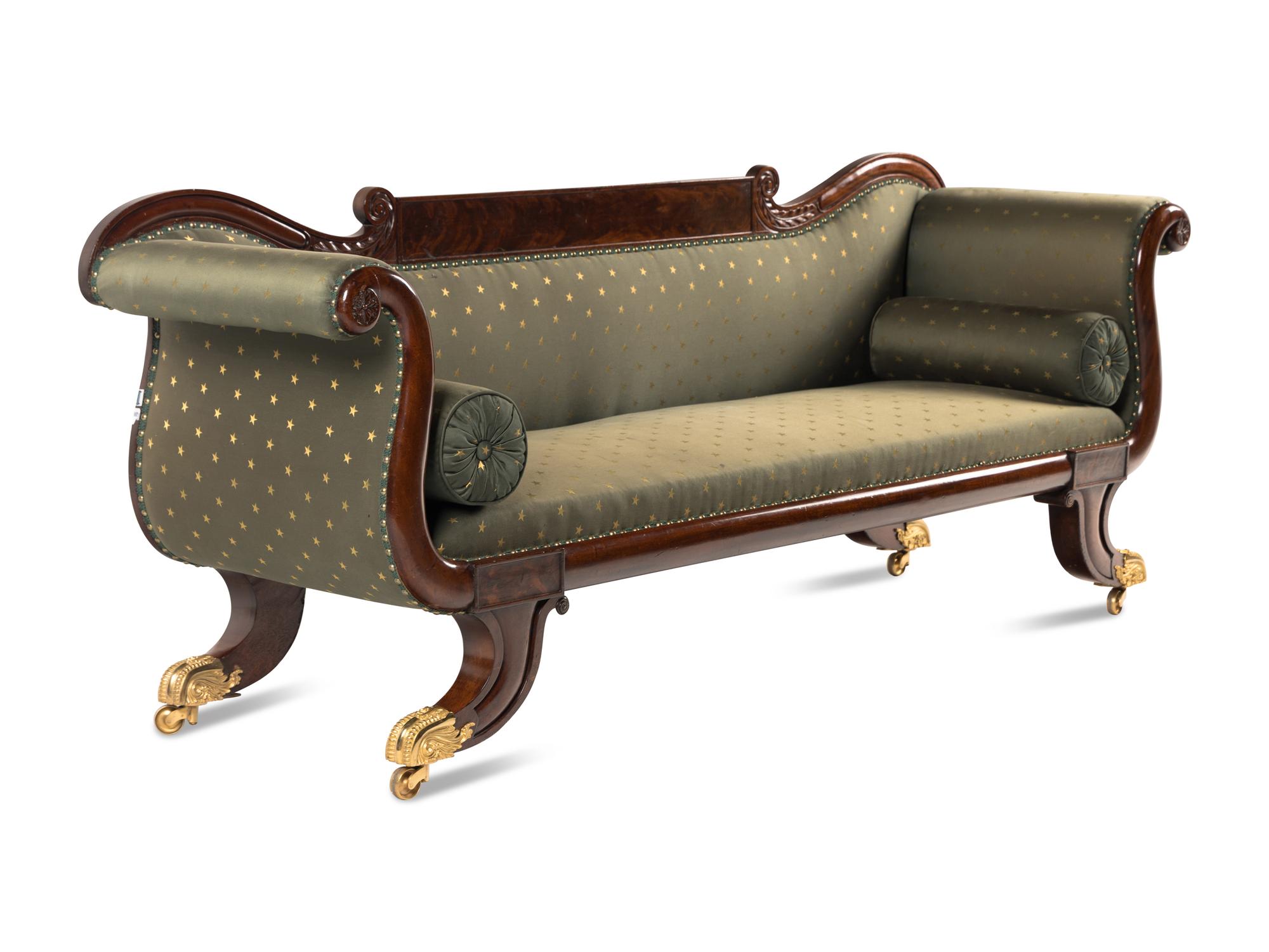 A Classical Carved and Figured Mahogany and Upholstered Sofa