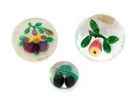 A Two Plums Glass Paperweight, a Chinese Pansy and Bud on Latticino Basket Glass Paperweight and a Pear Glass Paperweight