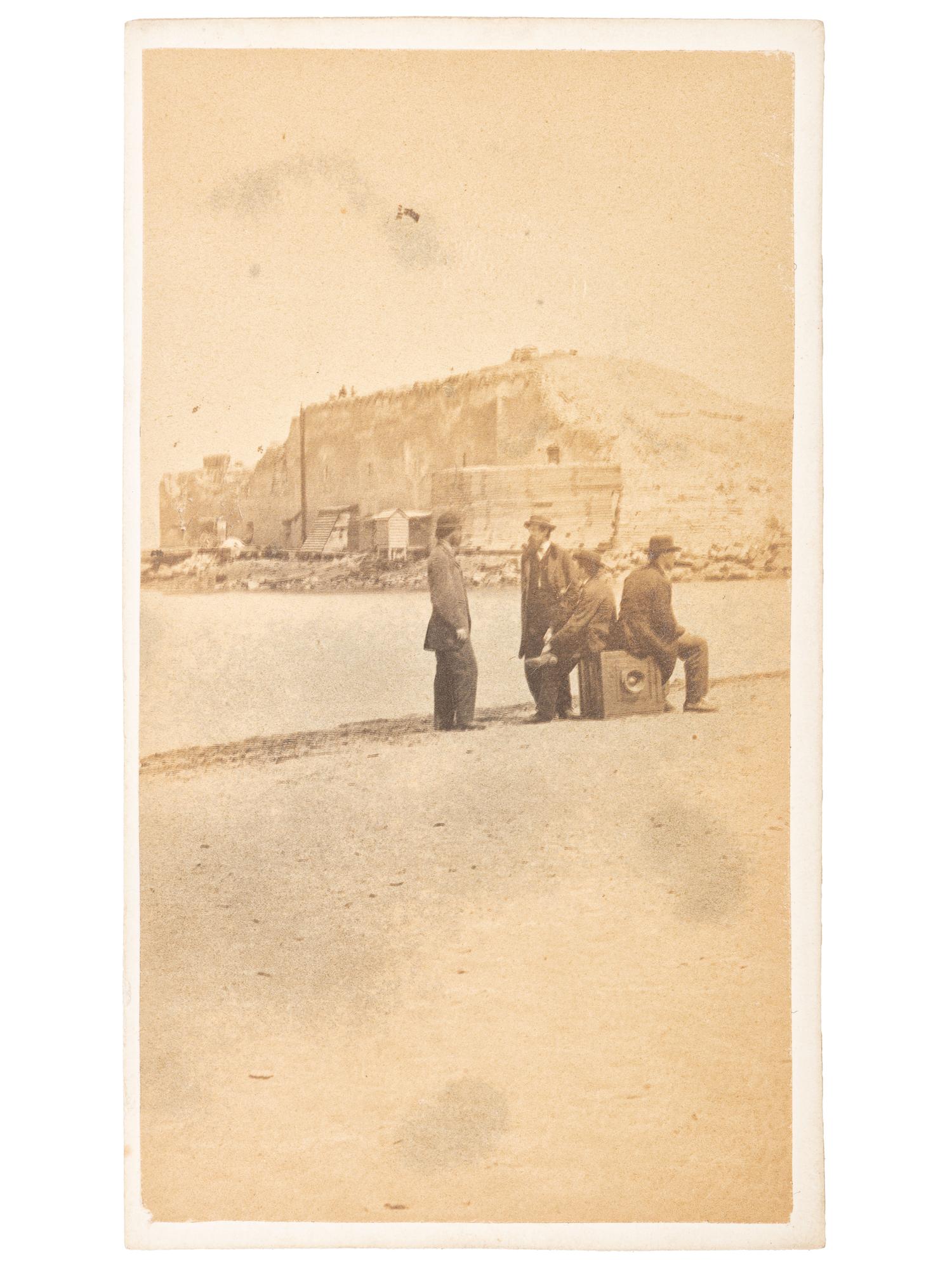 CDV featuring men sitting atop a large format camera on the sand bar in front of Ft. Sumter by H.C. Foster, Charleston, SC.