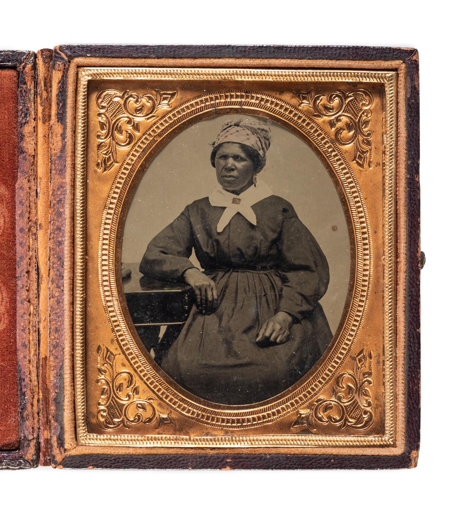 [EARLY PHOTOGRAPHY]. Sixth plate tintype featuring an African American woman. Ca 1870s.