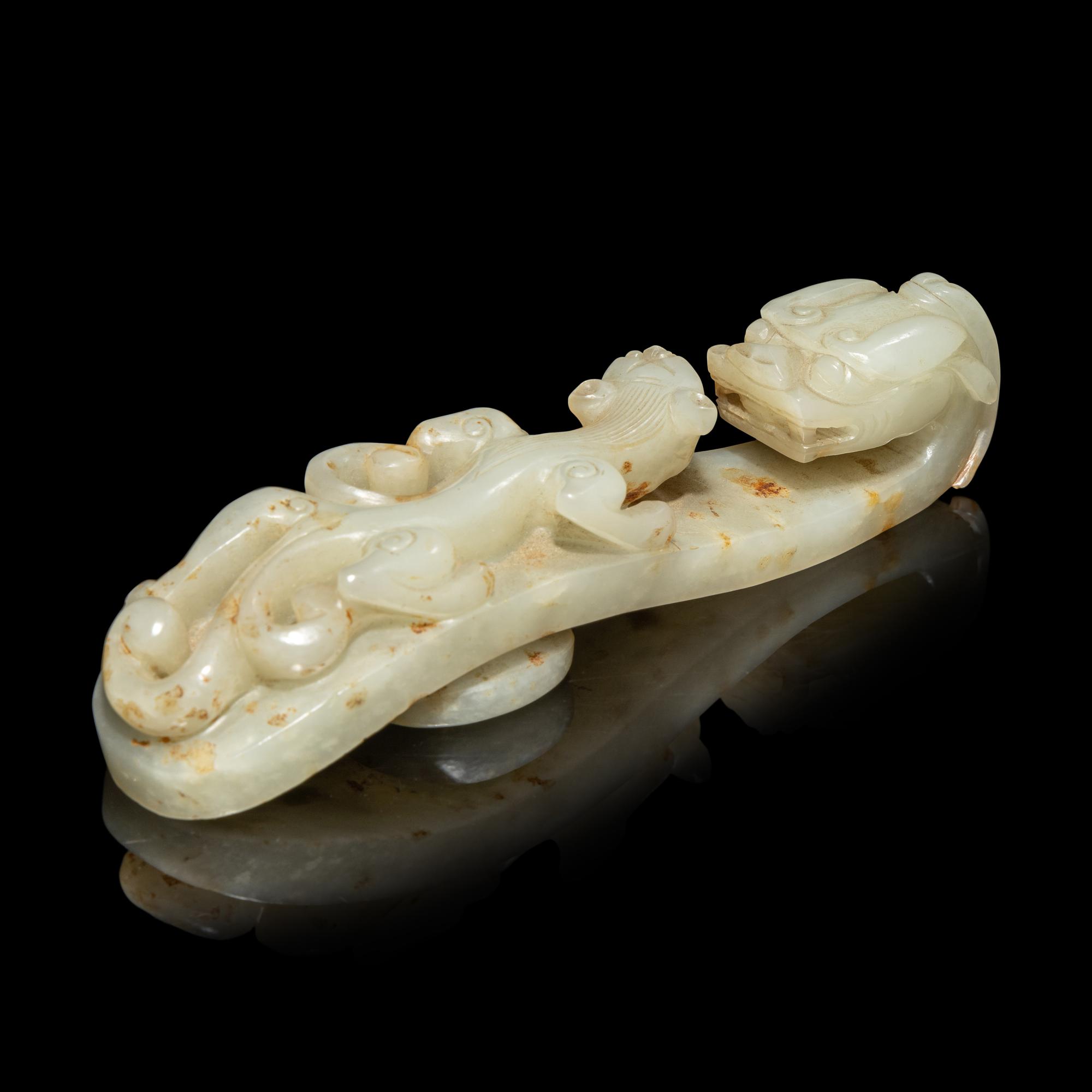 A Chinese Pale Celadon and Russet Jade 'Dragon' Belt Hook, Qing Dynasty 清 青白玉灑金皮蒼龍教子帶鉤