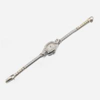 A lady's diamond and platinum bracelet watch, J.E Caldwell