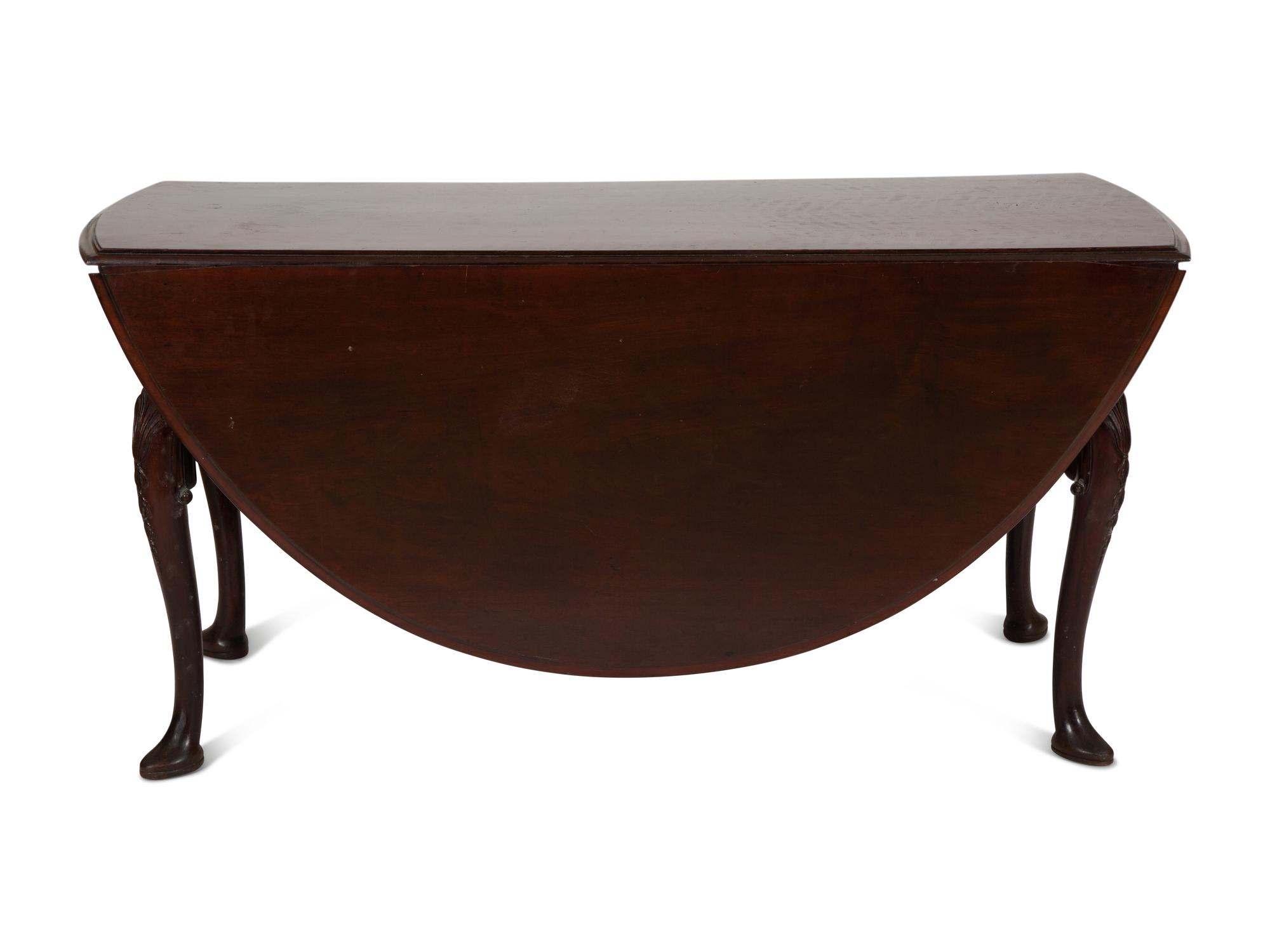 An Irish George II Style Carved Mahogany Drop Leaf Dining Table
