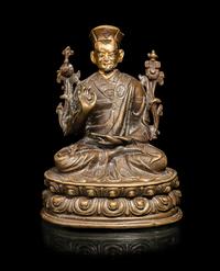 A Tibetan Parcel Gilt Bronze Figure of a Seated Lama