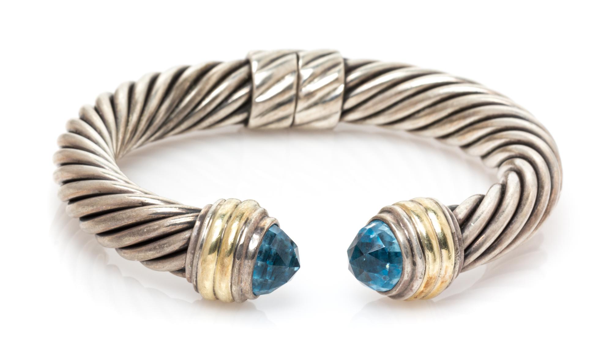 A Sterling Silver, 14 Karat Yellow Gold and Blue Topaz 'Cable Classics' Bracelet, David Yurman, 27.60 dwts.