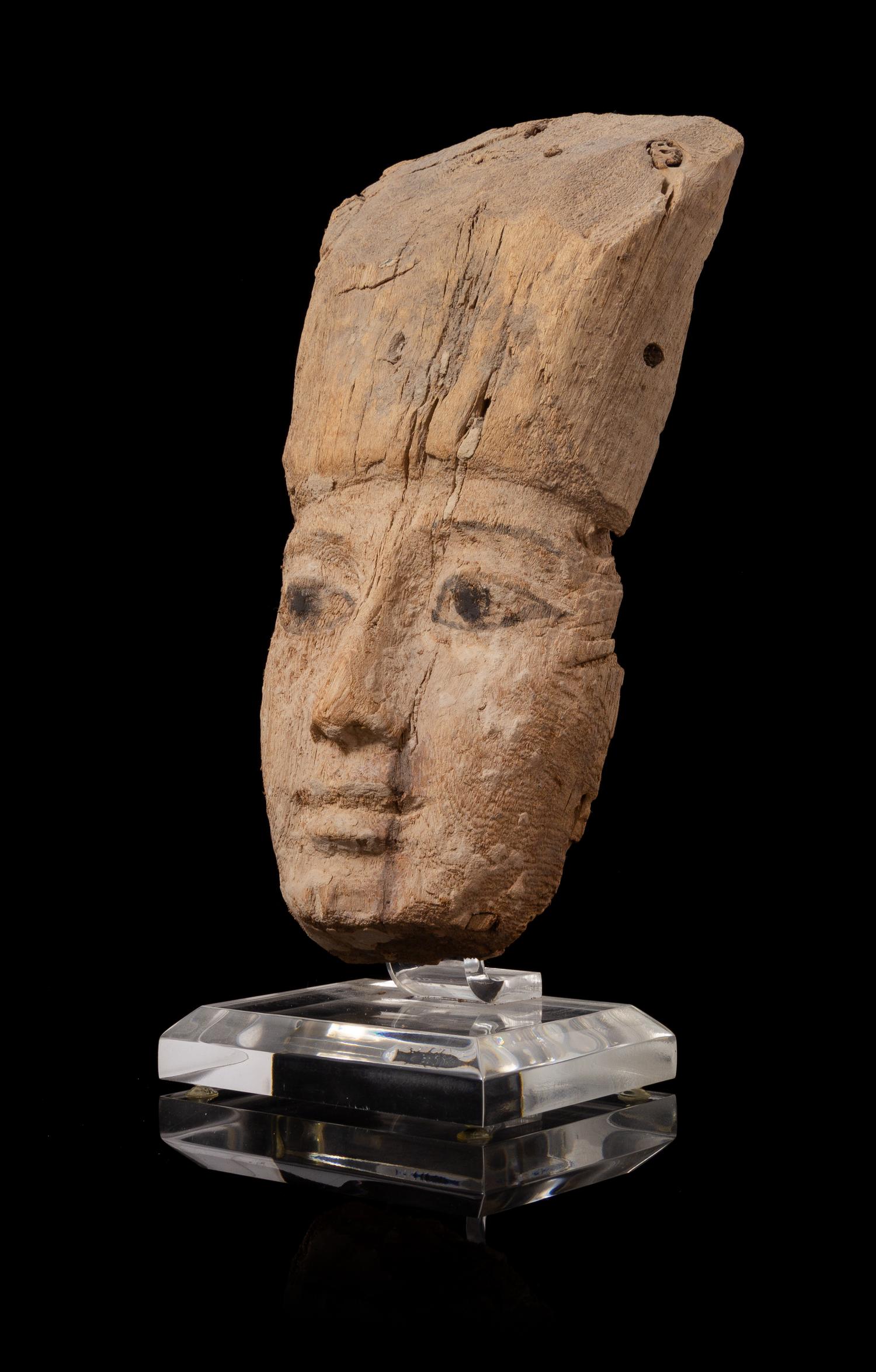 An Egyptian Painted Wood Mummy Mask Height 8 1/4 inches. — LATE PERIOD, DYNASTY 26-30, 664-343 B.C.E.