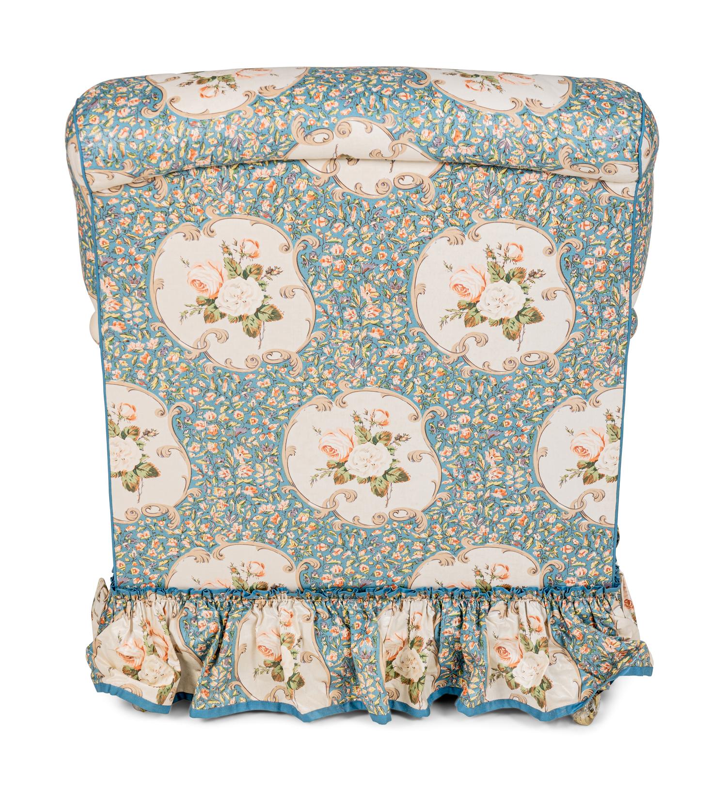 An English Chintz-Upholstered Easy Chair and Ottoman