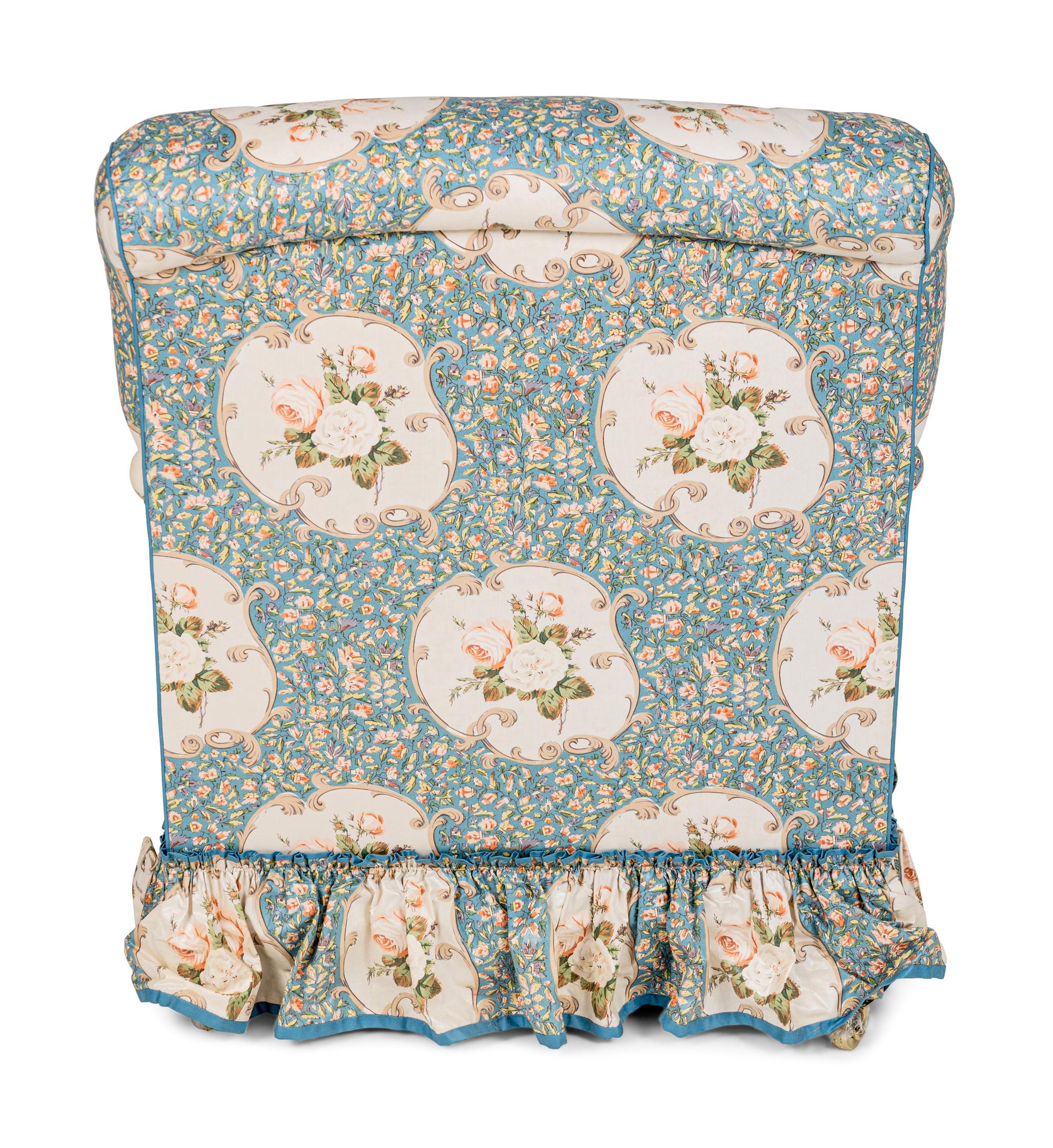 An English Chintz-Upholstered Easy Chair and Ottoman