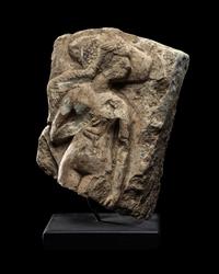 An Egyptian Limestone Fragment of a Mother Nursing her Child
