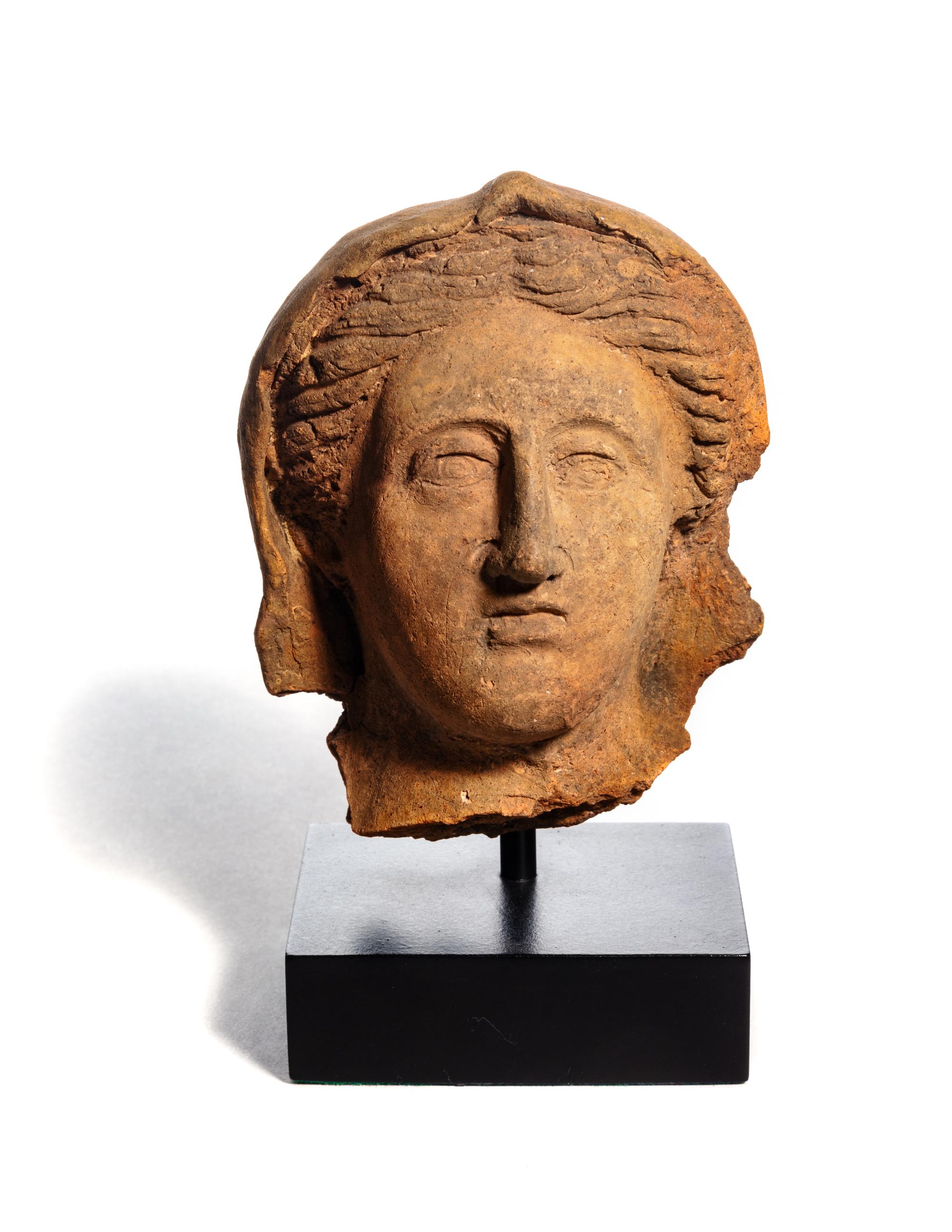 An Etruscan Terra Cotta Votive Head of a Woman