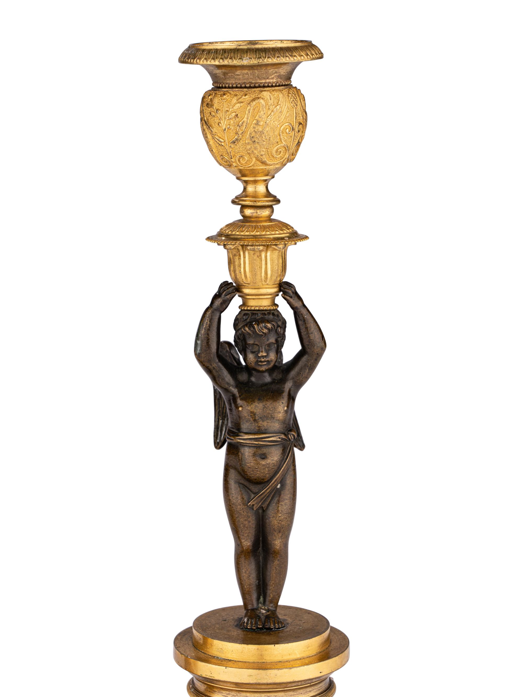 A Pair of Restauration Ormolu and Patinated Bronze Figural Candlesticks