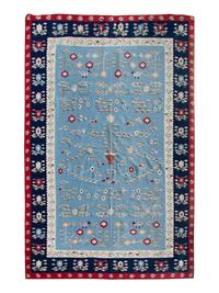 A Flat Weave Rug — 20TH CENTURY