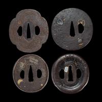 Group of eight Japanese inlaid iron tsuba Edo period or earlier