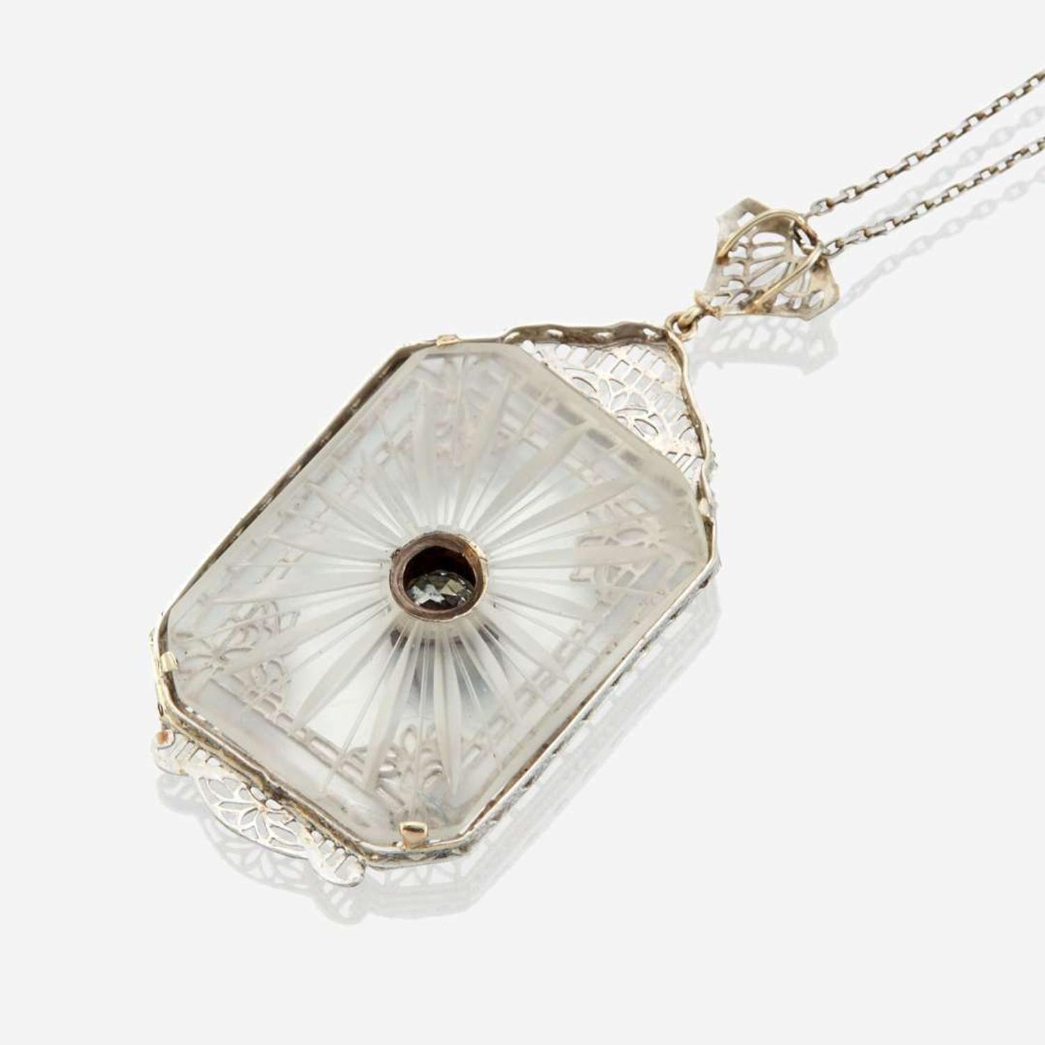 A diamond, rock crystal, and white metal pendant