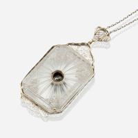 A diamond, rock crystal, and white metal pendant