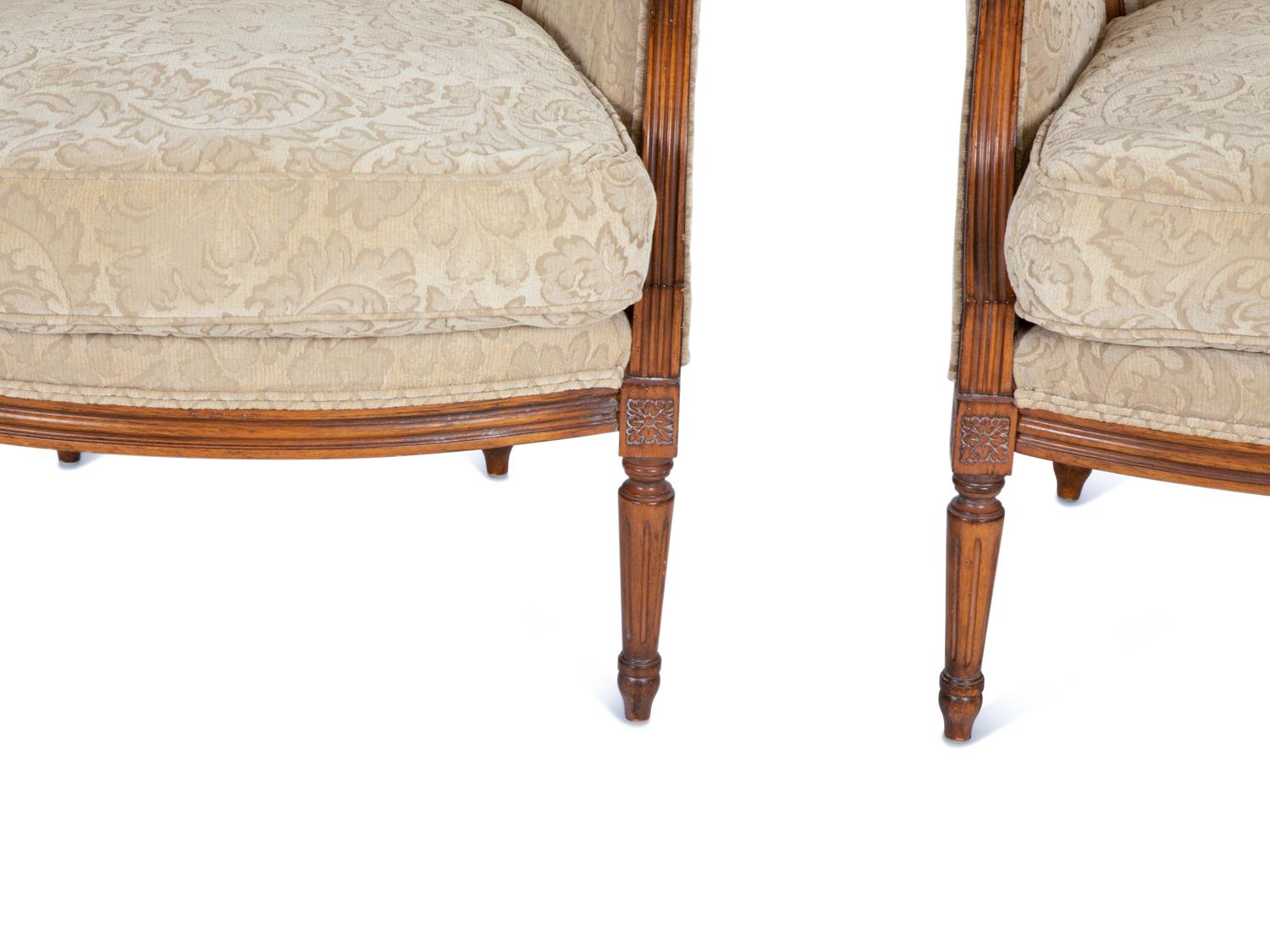 A Pair of Louis XVI Style Carved Walnut Bergères