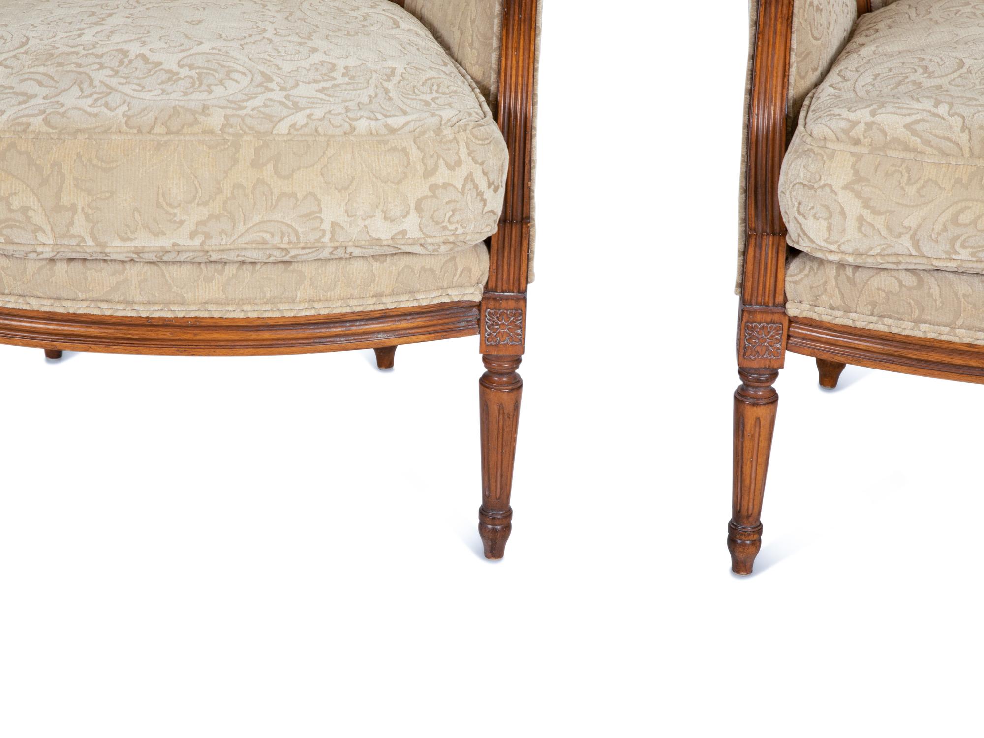 A Pair of Louis XVI Style Carved Walnut Bergères