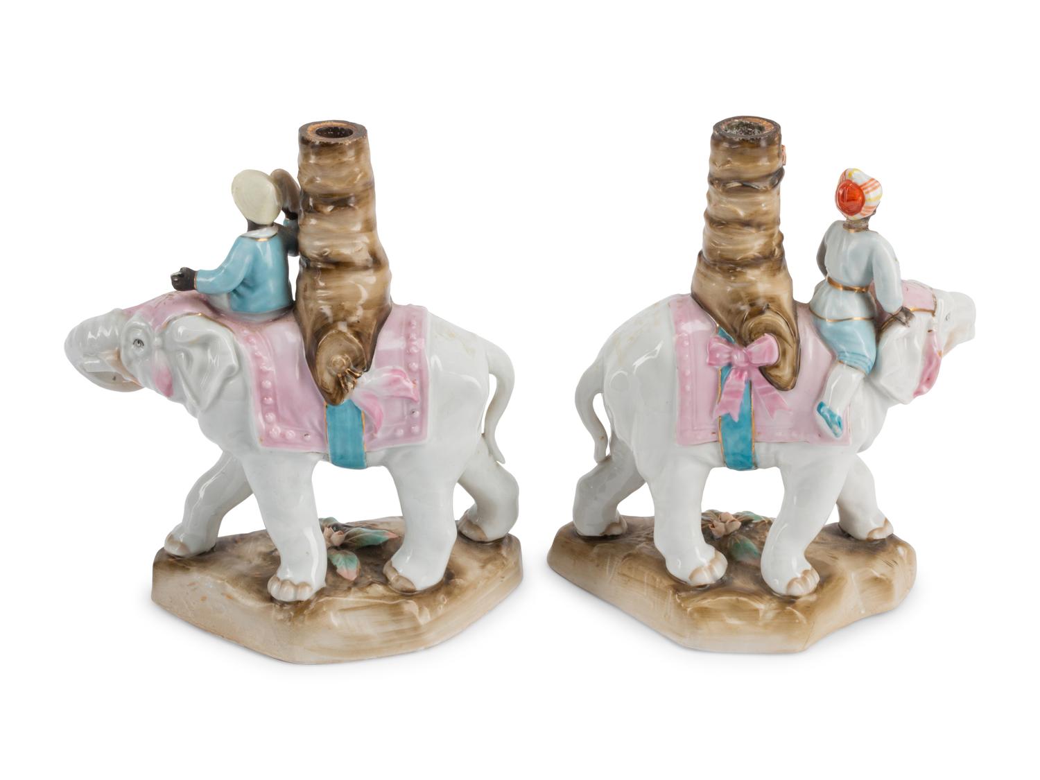 A Pair of Continental Porcelain Figural Candlesticks