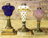 Three Glass Fluid Lamps. Height of tallest 10 3/8 inches.