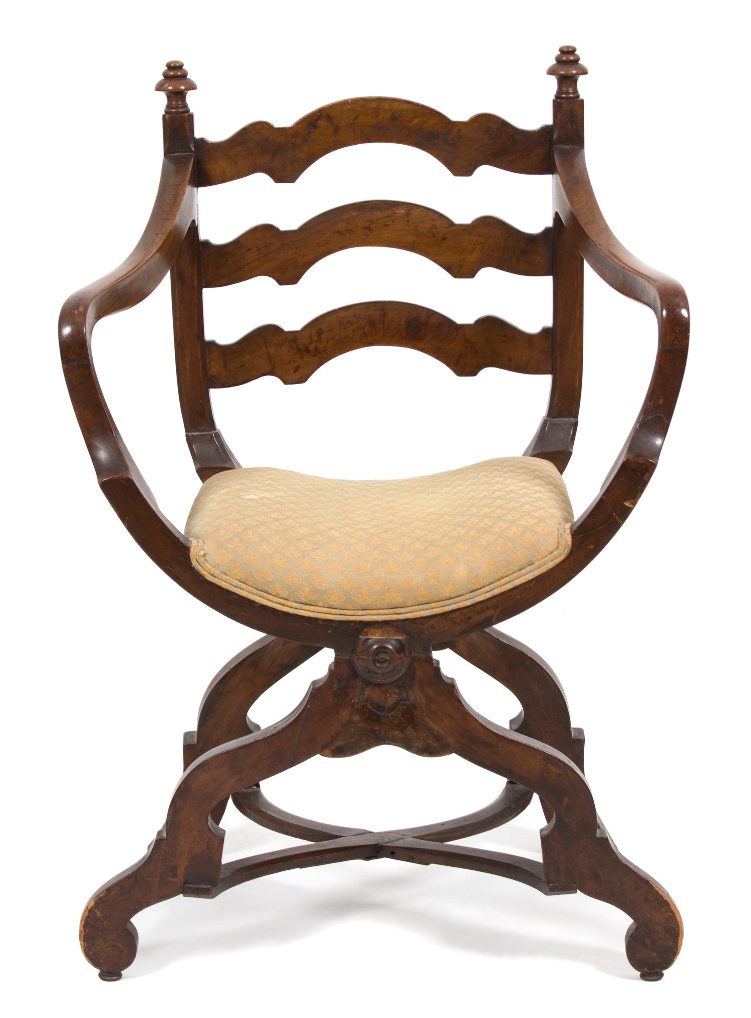 A Continental Savonarola Style Walnut Curule Ladder Back Armchair Height 37 inches. — 19TH CENTURY